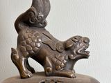 a bronze statue of a dog on top of a box