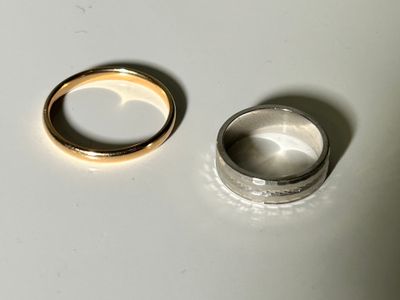 two rings sitting on a table next to each other