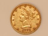 a close up of a gold coin with a woman ' s head on it