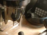a blender sitting on a counter next to a cell phone