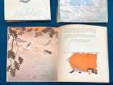 three books that are open on a blue table