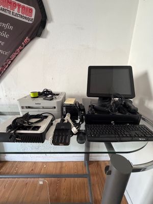a desk with a computer, keyboard, mouse, and other electronics on it
