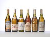 several bottles of wine are lined up on a table