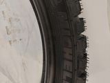 a close up of a motorcycle tire on a white surface