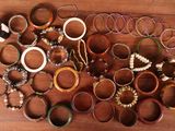 a lot of bracelets on a wooden table