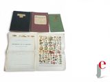 several books are stacked on top of each other on a white surface