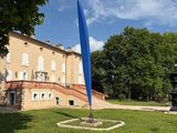 the large building has a blue flag in front of it