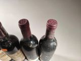several bottles of wine are lined up in a row
