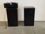 two speakers are sitting next to each other in a room