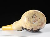 a vase with a yellow cone on top of it