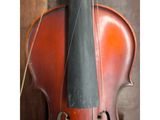 an image of a violin sitting on top of a hard wood floor