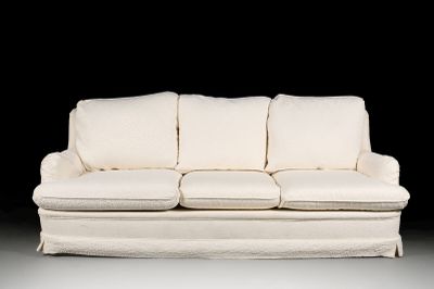a white couch that is sitting in the dark