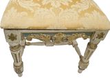 a white and gold chair with a floral upholstered seat