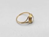 a close up of a gold ring on a white surface