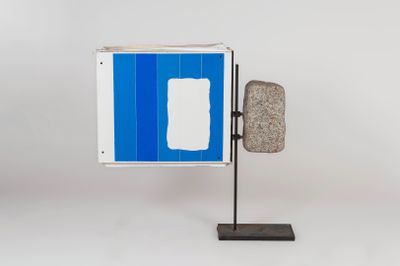 a blue and white sign on a metal stand