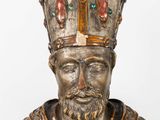 statue of a man with a crown on his head and a cross on his chest