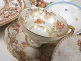 many plates and cups that are sitting on a table