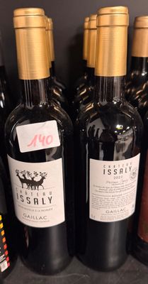 bottles of wine are lined up on a shelf in a store