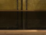two brown leather couches sitting next to each other