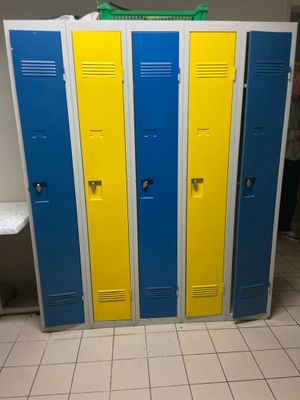 three blue and yellow lockers next to each other in a bathroom