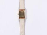 a close up of a watch on a white surface with a white background