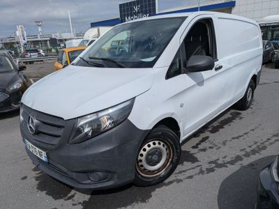 la camionnette blanche est garée dans le parking à côté d'autres voitures