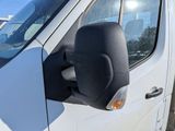 an image of a side view mirror of a white van