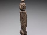 an image of a statue of a man with a stack of rocks on his head