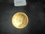 une pièce d'or sur laquelle figure le visage d'un homme