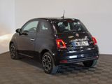 a small black car that is parked in a room