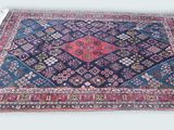 an oriental rug on a white background with a blue and red design