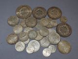 a pile of silver coins on a blue surface