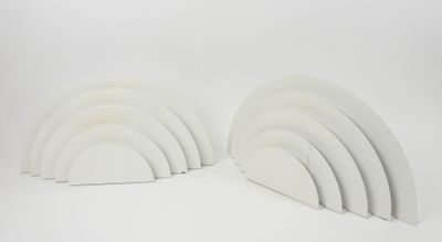 two white bookends are stacked on top of each other on a white surface