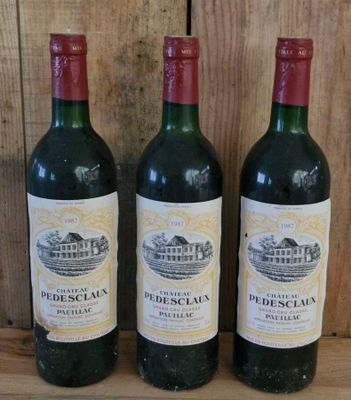 three bottles of wine sit on a wooden shelf in front of a wooden wall