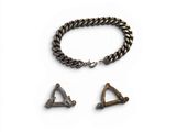 a close up of a metal bracelet with a triangle and two other items