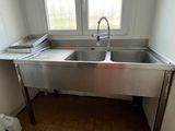 a kitchen with a sink and a window in it