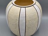 a white vase with a cracky design on it