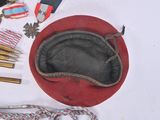 a red hat and other items on a white table