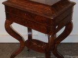 a small wooden table with a drawer on top of it