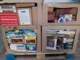two boxes of books on a pallet in the street