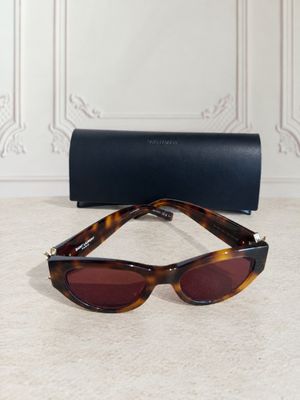 a pair of sunglasses sitting on top of a table next to a case