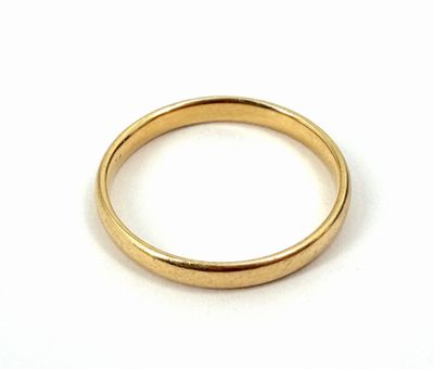a close up of a gold ring on a white surface