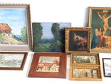 many framed pictures and paintings on the table