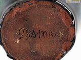 a close up of a brown vase with writing on it