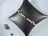 a close up of a black pillow with a ring on top of it
