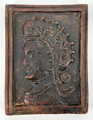 a close up of a wooden plaque with a man wearing a crown