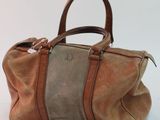 an image of a brown and tan handbag sitting on a white surface
