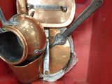 pots and pans are stacked on top of each other in a red container