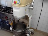 a mixer that is sitting in a kitchen next to a stove