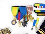 many medals and medals laid out on a white surface